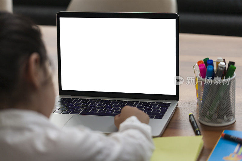 Little girl on the internet with laptop computer doing homework